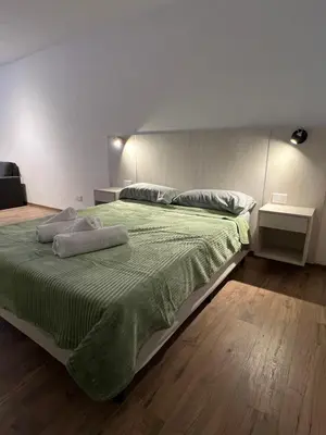 a bedroom with a large bed with two pillows on it at Departamento Carlos Paz in Villa Carlos Paz