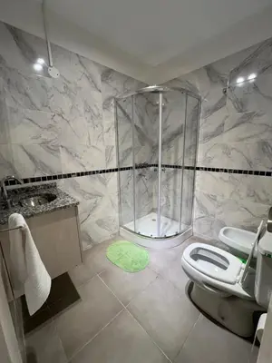 a bathroom with a shower and a toilet and a sink at Departamento Carlos Paz in Villa Carlos Paz