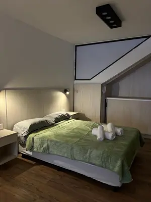 a bedroom with a large bed with a large window at Departamento Carlos Paz in Villa Carlos Paz