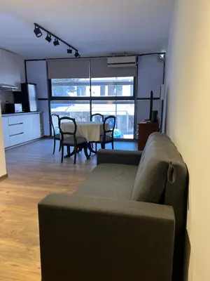 a living room with a couch and a table at Departamento Carlos Paz in Villa Carlos Paz