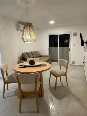 a living room with a table and chairs and a couch at Departamento en calle Obispo Trejo NVA CBA in Cordoba