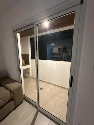 a sliding glass door in a room with a bedroom at Departamento en calle Obispo Trejo NVA CBA in Cordoba