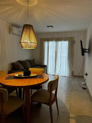 a living room with a table and a couch at Departamento en calle Obispo Trejo NVA CBA in Cordoba