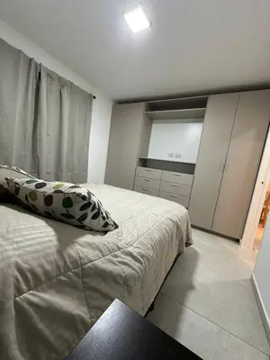 a bedroom with a bed and a window and cabinets at Departamento en calle Obispo Trejo NVA CBA in Cordoba