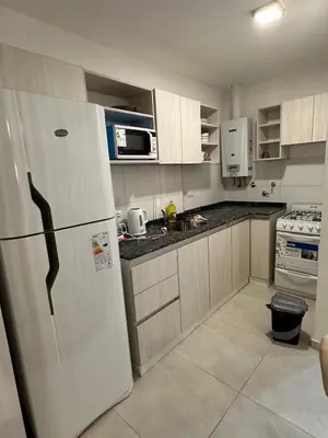 a kitchen with a white refrigerator and a stove at Departamento en calle Obispo Trejo NVA CBA in Cordoba