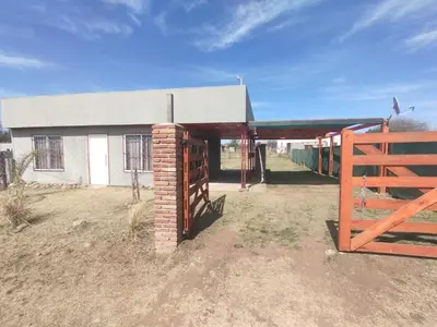 a building with a fence and a gate in front at El paraiso in Villa del Dique