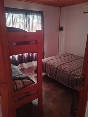 a bedroom with two bunk beds and a window at El paraiso in Villa del Dique