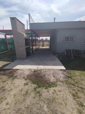 a house with a garage and a building at El paraiso in Villa del Dique
