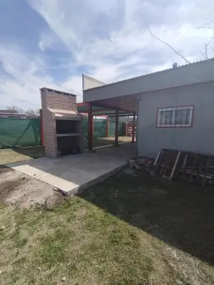 a house with a patio and a building at El paraiso in Villa del Dique