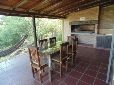 a table and chairs on a patio with a fireplace at Cabañas los amigos Chañar in Potrero de Garay