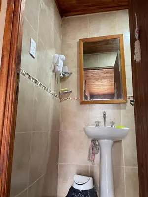 a bathroom with a sink and a mirror at Kapo TEAM , la calandria in Villa Amancay