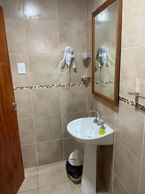 a bathroom with a sink and a mirror at Kapo TEAM , la calandria in Villa Amancay