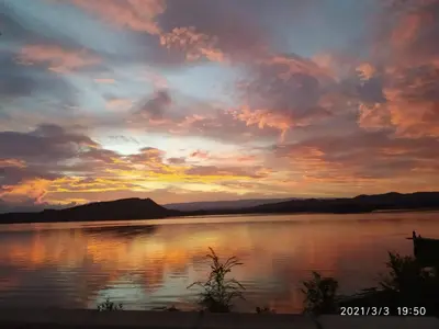 a sunset over a large body of water at Kapo TEAM , la calandria in Villa Amancay