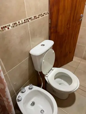 a bathroom with a toilet and a sink at Kapo TEAM , la calandria in Villa Amancay