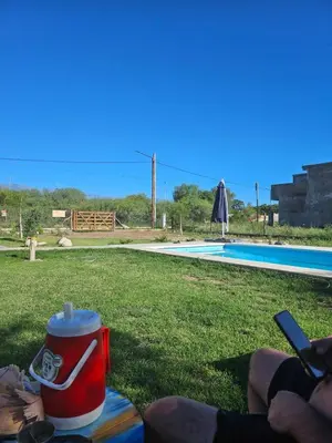 a drink can sitting on a table next to a pool at Cabaña La Luna in San Javier