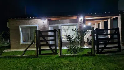 a house with a gate in front of it at night at Cabaña La Luna in San Javier