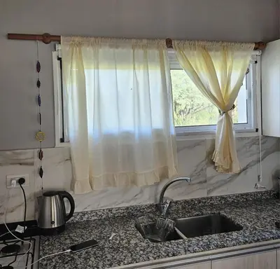 a kitchen counter with a sink and a window at Cabaña La Luna in San Javier