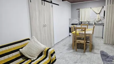 a living room with a couch and a table at Cabaña La Luna in San Javier