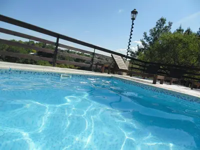 a swimming pool with a fence around it at Cabañas los amigos Tala in Potrero de Garay