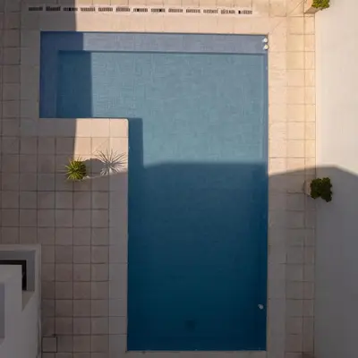 a large blue swimming pool in a building at Complejo Solares in Alta Gracia