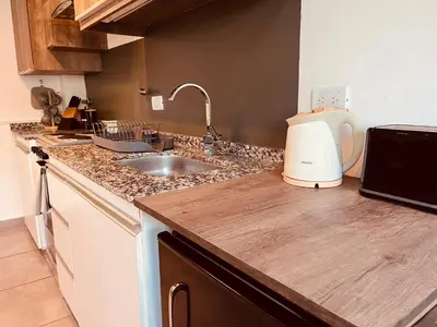 a kitchen counter top with a sink and a blender at Aguaribay duplex Nuevo Centro in Cordoba