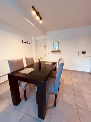 a dining room with a wooden table and chairs at Aguaribay duplex Nuevo Centro in Cordoba