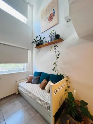 a couch in a room with a window at Aguaribay duplex Nuevo Centro in Cordoba