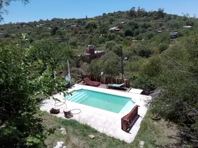 a swimming pool in the middle of a hill at Casa nacha in Cuesta Blanca