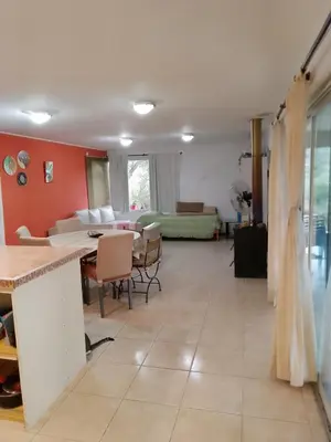 a living room with a table and a couch at Casa nacha in Cuesta Blanca