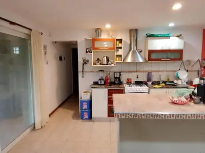 a kitchen with white cabinets and a counter at Casa nacha in Cuesta Blanca