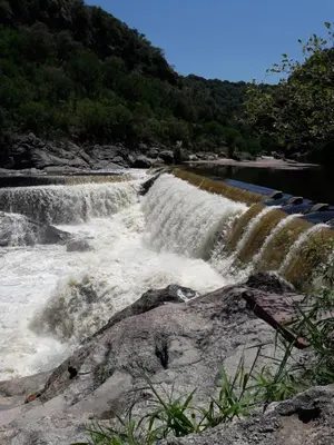 a waterfall in the middle of a river at Casa nacha in Cuesta Blanca