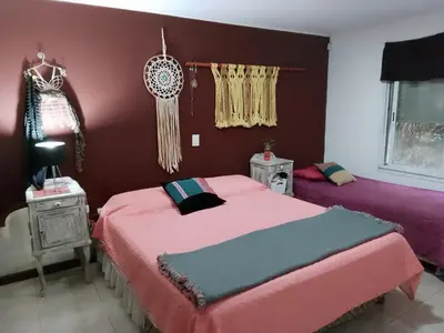 two beds in a room with purple walls at Casa nacha in Cuesta Blanca