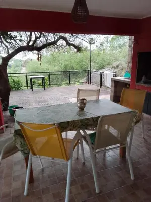 a table and chairs in a room with a patio at Casa nacha in Cuesta Blanca