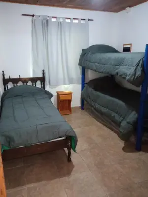 a bedroom with two bunk beds and a window at Los 3 soles in Villa Ciudad Parque