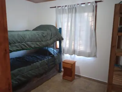 a bedroom with a bunk bed and a window at Los 3 soles in Villa Ciudad Parque
