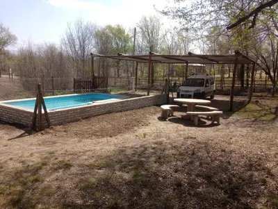 a picnic table and a pavilion next to a pool at Los 3 soles in Villa Ciudad Parque