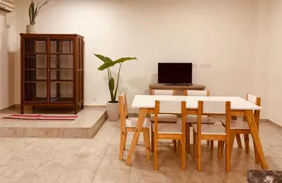 a dining room with a table and chairs and a tv at Departamento Confortable 2 in Cordoba