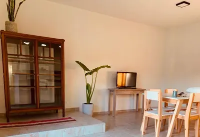 a living room with a table and a tv at Departamento Confortable 2 in Cordoba