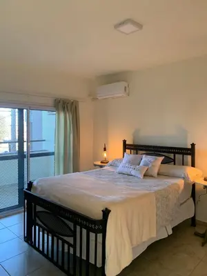 a bedroom with a large bed and a balcony at Departamento Confortable 2 in Cordoba