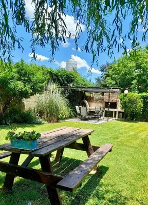 a wooden picnic table in a yard with a patio at Cabañas Lauquen Villa Carlos Paz in Villa Carlos Paz
