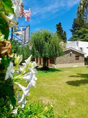 a view of the house from the garden at Cabañas Lauquen Villa Carlos Paz in Villa Carlos Paz