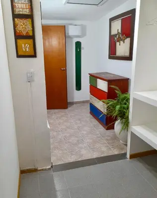 a hallway with a door and a room at Cabañas Lauquen Villa Carlos Paz in Villa Carlos Paz