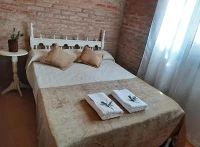 a bedroom with a bed with two towels on it at Cabaña Emmanuel in Santa Rosa de Calamuchita