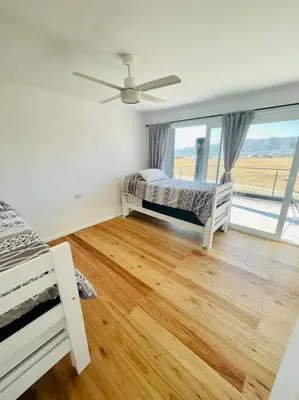 a bedroom with a bed and a large window at Casa Puerto del Águila in La Estancia
