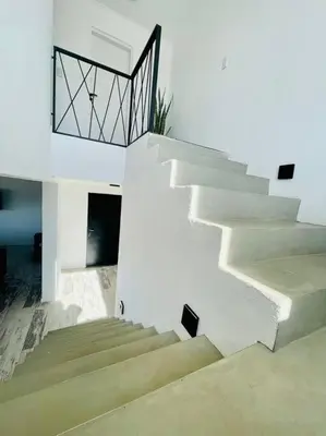 a staircase in a white building with a railing at Casa Puerto del Águila in La Estancia