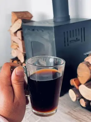 a person holding a cup of coffee on a table at Casa Puerto del Águila in La Estancia