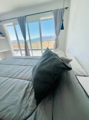 a large pillow sitting on a bed in a bedroom at Casa Puerto del Águila in La Estancia