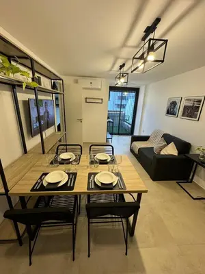 a dining table and chairs in a living room at Depto a 3 cuadras de Patio Olmos in Cordoba