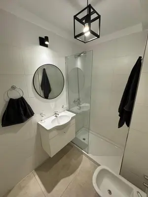 a bathroom with a sink and a shower and a mirror at Depto a 3 cuadras de Patio Olmos in Cordoba