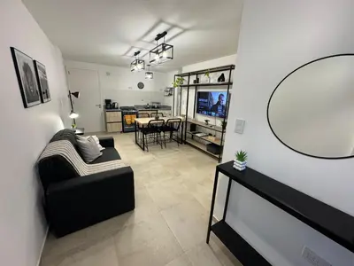 a living room with a couch and a table at Depto a 3 cuadras de Patio Olmos in Cordoba